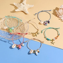 Detailed view of six adjustable woven beach bracelets with shell and sea turtle charms