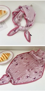 Close-up of pink floral pleated silk scarf showing fine accordion pleats and texture