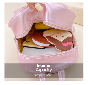 Macro view of pink pearlescent backpack interior showing storage capacity and smooth zipper