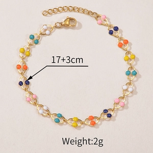 Detail of colorful enamel bead chain bracelet in gold finish with dimensions 17 plus 3cm