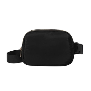 Classic black nylon waist bag for women featuring golden metal zippers and adjustable strap
