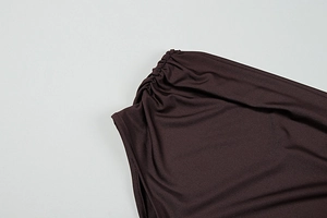 Detail of elegant chocolate brown ruched fabric with premium stitching and elastic texture
