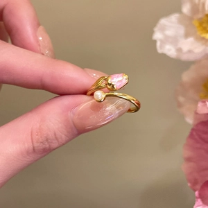 Detailed view of an 18k gold-plated open ring with pink tulip design and white pearl