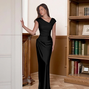 Detailed view of black satin evening gown featuring asymmetrical neck and sleek finish