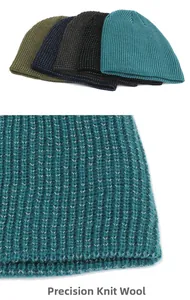 Detailed close-up of tight vertical rib knit texture and elastic hem on the beanie