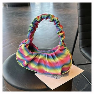 Detail of colorful rainbow gradient pleated cloud bag with unique gathered fabric texture