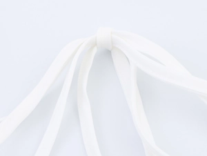 Detailed close-up of white fabric drawstring knot on a sweet floral two-piece set