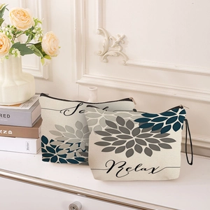 Floral canvas makeup bag set with Relax print and zipper closure in home setting