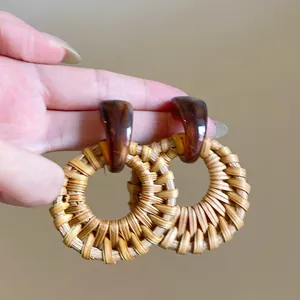 Bohemian style handmade raffia drop earrings with brown resin marble pattern top
