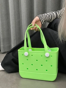 Macro detail of fluorescent green EVA beach tote showing hollow holes and smooth texture