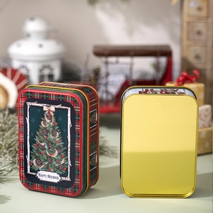 Detail view of a Christmas tin box with red plaid patterns and festive holiday illustrations