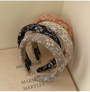 Close-up of knit headbands with ethnic patterns and handmade labels on vintage board