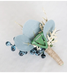 Close-up of artificial flower corsage back with twin twine stem and green safety clip