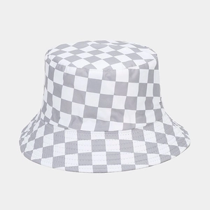 Macro shot of checkered reversible bucket hat showing stitch detail and grey fabric