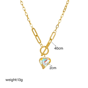 Gold OT clasp chain necklace featuring a multifaceted rainbow crystal heart pendant