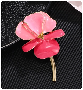 Detailed view of enamel iris flower brooch with pink and crimson gradient petals