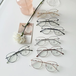 Detail of assorted lightweight metal blue light blocking glasses with striped temples