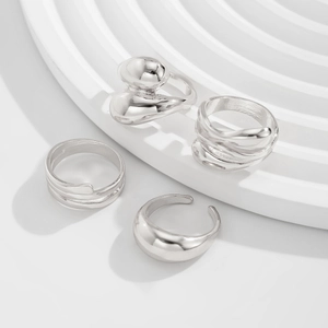 Macro shot of silver punk irregular rings with organic geometric and layered metal textures