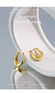 Macro detail of gold S925 sterling silver U-shaped hoop earrings on a geometric stand