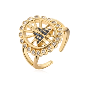 Gold plated Virgin Mary ring with blue zircon and sparkling crystals on white background