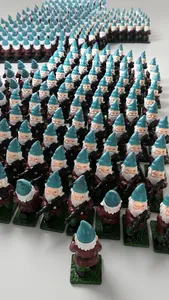 Mass-produced garden gnome figurines with blue hats and rifles in a production setting