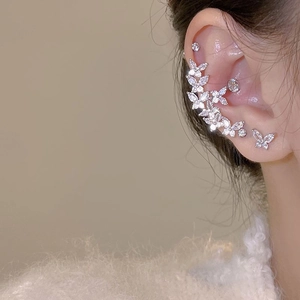 Detailed close-up of elegant silver butterfly stud earrings set with sparkling zircons