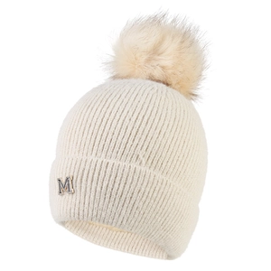 Dettaglio della maglia e decorazione con lettera M argentata su un cappello invernale
