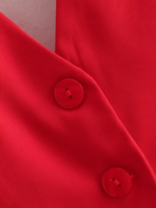 Detailed macro view of red twill fabric texture and matching resin buttons on halter top