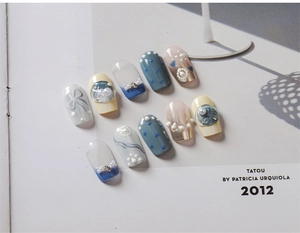 Detailed macro shot of 10-piece handmade press-on nails with blue bows and pearl accents