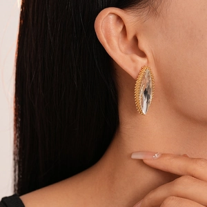 Macro detail of luxury marquise-cut crystal earrings with gold micro-bead edging