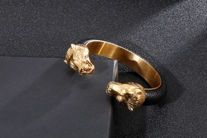 Detail of golden double horse head design on punk style black leather stainless steel bracelet