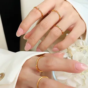 Set of five minimalist gold rings with colorful rainbow gemstones for women stacking style
