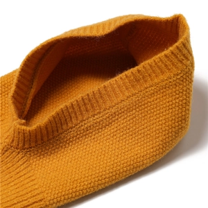 Detail of the yellow knitted winter hood neck warmer showing texture and ribbing