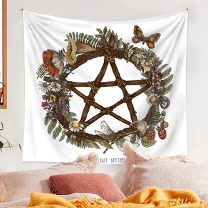 Detail view of Bohemian tapestry with pentagram wreath and nature elements over a bed