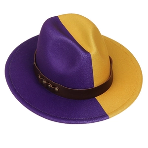 Detail of two-tone wool felt fedora with brown leather band and metal rivet accents