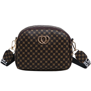 Brown monogram crossbody bag with gold heart detail and printed wide shoulder strap