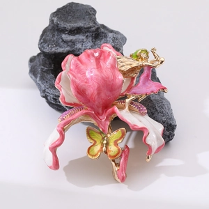Luxury vintage flower brooch with pink petals, butterfly and fairy motifs on dark rock