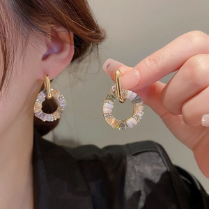 Vintage gold hoop earrings with iridescent crystals and rhinestones shown on a model