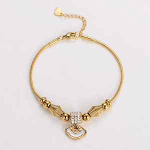 Macro view of a gold snake chain bracelet with Ruyi cloud pendant and lobster clasp