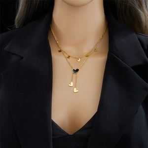 Minimalist double-layer gold heart necklace for women featuring a black heart tassel pendant