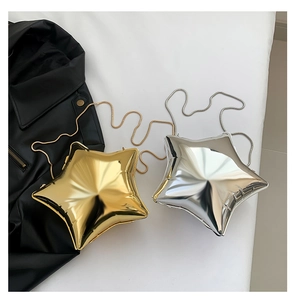 Flat lay of gold and silver star-shaped chain bags with metallic mirror finish