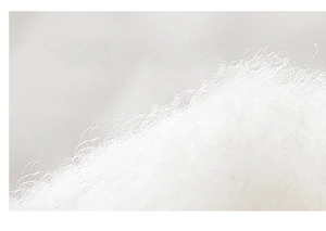 Macro detail of high-quality soft white cotton fibers showing breathable fabric texture