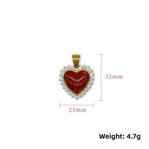 Detail of 18K gold heart pendant with red stone and zircons, 32mm x 25mm size