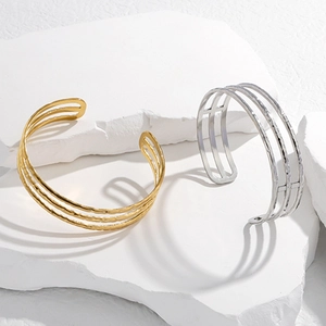 Minimalist gold and silver triple-layered open cuff bracelet with hammered metal texture