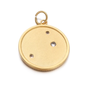 Close-up of gold star and moon pendant with three inset zircons and polished finish