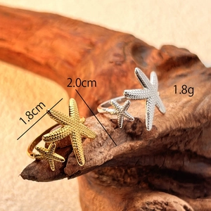 Vintage stainless steel starfish rings for men in gold and silver finish on wood