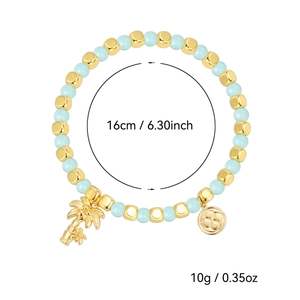 Bohemian gold beaded bracelet with coconut tree and floral disc charms for beach style