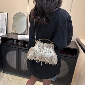 Detail of champagne gold shell bag with shiny sequins and elegant tassel fringe