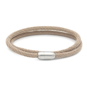 Braided Milan cord bracelet in beige with a magnetic silver clasp on white background