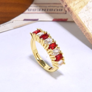 Macro shot of gold adjustable ring featuring oval red and white zircon stones inlay